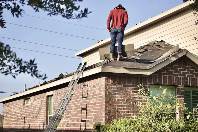 Professional roofer working on a residential roof in Monrovia